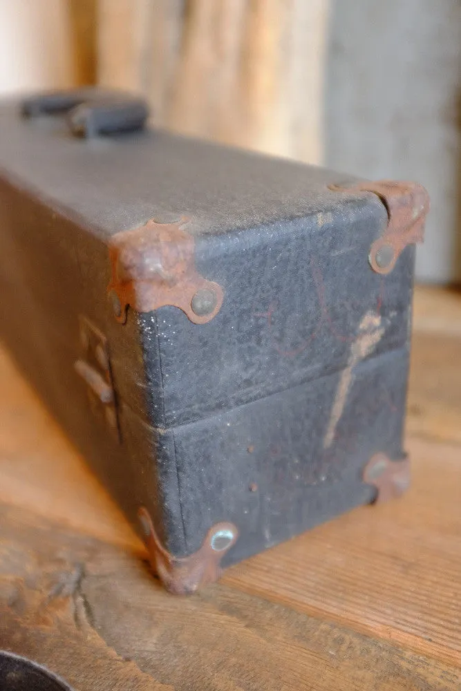 Alexander's rusty black suitcase