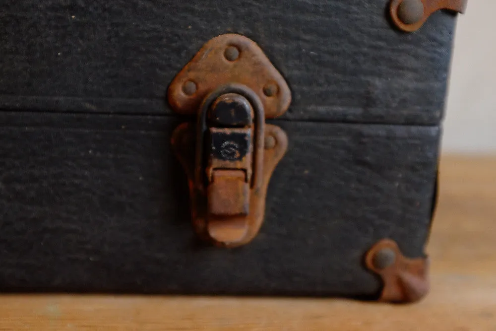 Alexander's rusty black suitcase