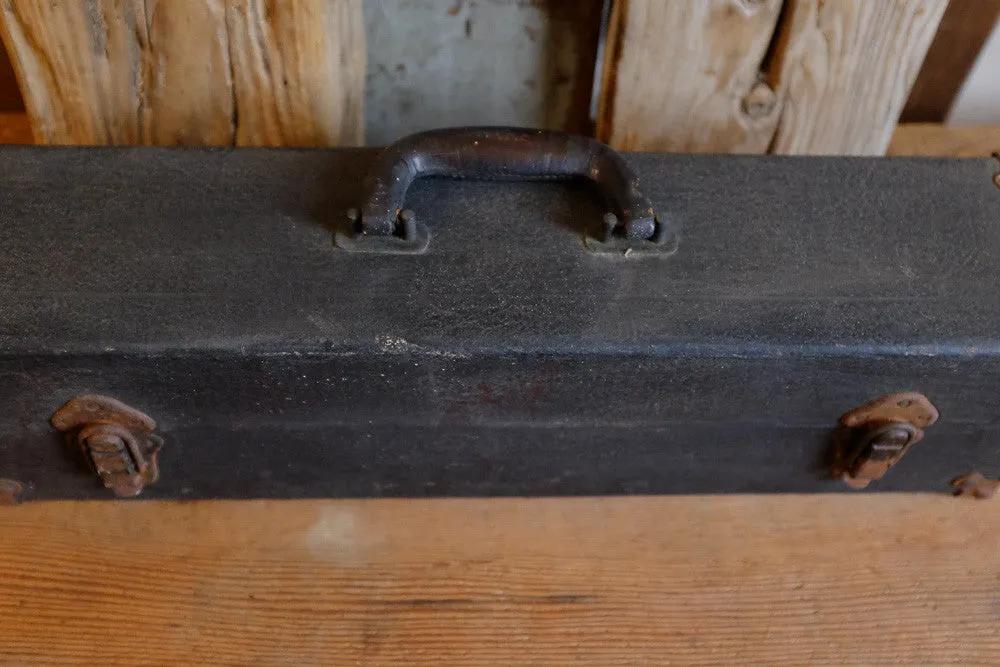 Alexander's rusty black suitcase